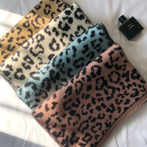 Close-up of leopard print knitted scarves in four colors with ribbed edge detail