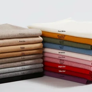 Folded solid cashmere feel scarves in multiple colors on a minimalist white background
