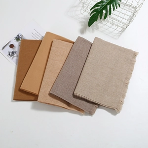 Detailed close-up of earth-toned pashmina scarves with soft fringe edges and fabric texture