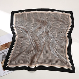 Elegant houndstooth silk square scarf in black and white with a glossy satin finish