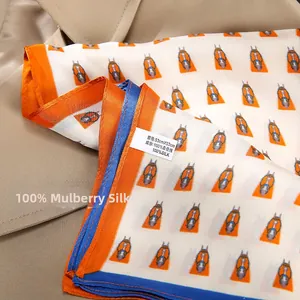 Close-up of 100% mulberry silk square scarf with horse print and hand-rolled edges