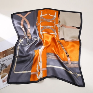 Detail of luxury silk square scarf with classic equestrian harness print in orange and grey