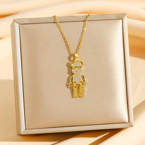 Hip-hop style gold bear pendant necklace with sparkling zircons on silk background