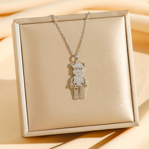Mechanical bear pendant necklace with white zircons on a luxury gift box
