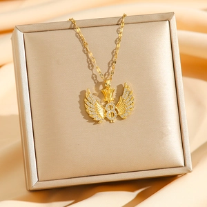 Golden crown and wing infinity necklace with white zircons on a luxury gift box