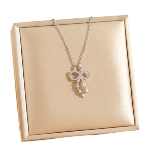 Titanium steel silver bow necklace with full diamond tassels on champagne satin gift box