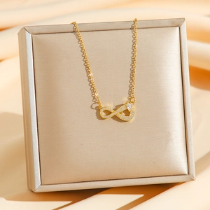 Golden titanium steel necklace with infinity symbol pendant and sparkling cubic zirconia