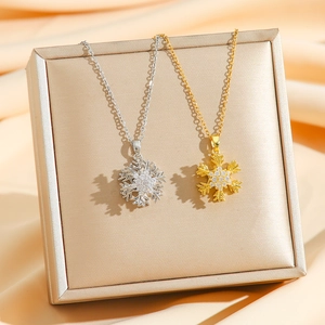 Elegant rotating snowflake pendant necklace with cubic zirconia in gold and silver finish
