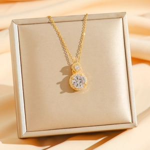 Vintage emerald-style gold necklace with double halo cubic zirconia pendant on silk