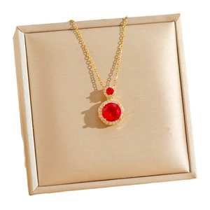 Vintage gold necklace featuring dual emerald-cut red stone pendants with crystal halo