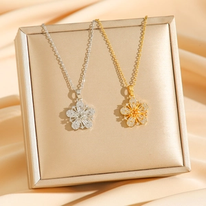 Micro-inlaid zircon flower pendant necklace in gold and silver finish on silk background