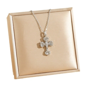 Golden vintage cross pendant with white zircon inlays on a bamboo chain necklace