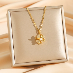 Rotating windmill necklace with white pearl and sparkling crystals on golden chain
