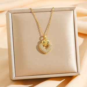 Luxurious gold titanium steel necklace with sparkling double heart pendant on silk