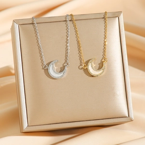 Elegant crescent moon necklaces in gold and silver with zircon stones and mother of pearl
