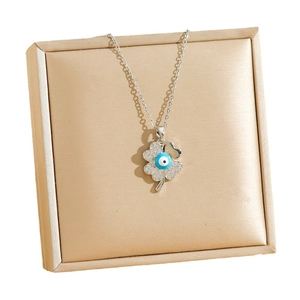 Silver sunflower clover necklace with evil eye charm and crystals in a jewelry box