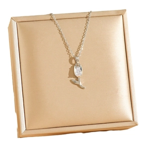 Silver tulip pendant necklace with sparkling teardrop zircon on a jewelry box