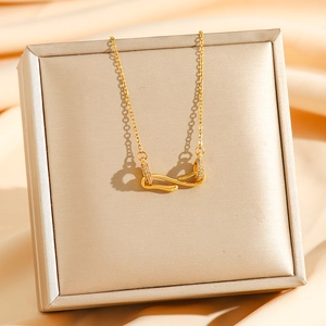Golden snake-shaped pendant necklace with sparkling zircons on elegant champagne silk fabric