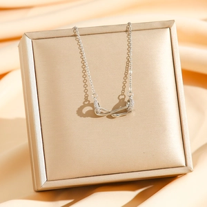 Vintage silver snake pendant necklace with zircon crystals on an elegant display stand