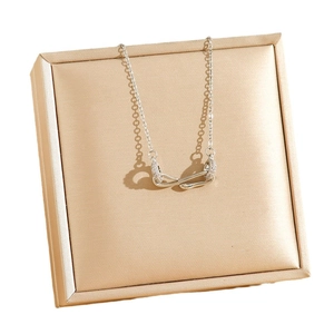 Silver-tone snake knot pendant necklace with cubic zirconia on elegant satin box