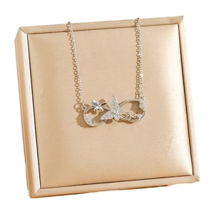 Silver infinity butterfly necklace with crystals on a champagne satin jewelry gift box