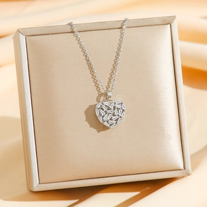Elegant silver heart pendant necklace with baguette-cut zircons on champagne satin
