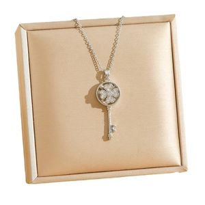 Rotating four-leaf clover key pendant necklace with sparkling cubic zirconia in silver
