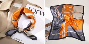 Detail of silk square scarf with horse bridle pattern tied on a khaki trench coat