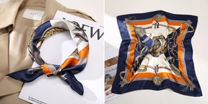 Detailaufnahme von Seidentuch mit Marine-Orange-Kettenmuster am Trenchcoat gebunden