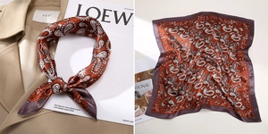 Detail of red and purple paisley silk scarf styled on a trench coat with smooth texture
