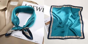 Detailed view of dark green silk scarf with vintage chain print and satin finish