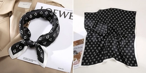 Detail of silk square scarf featuring black base with white D letter print and white border