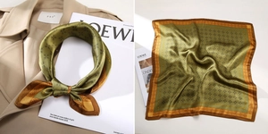 Detail of square silk scarf featuring olive green geometric print and smooth satin texture