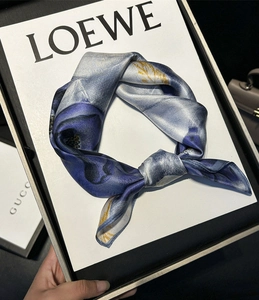 Detailed view of luxury floral pattern silk scarf with blue and white accents