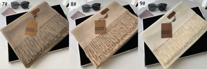 Detailed comparison of beige and camel cashmere-feel scarves with fringe and brand label
