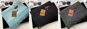 Three premium solid color scarves in light blue, black, and grey with fringe tassels