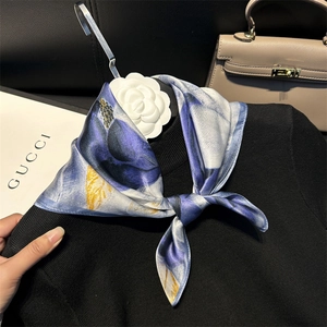 Elegant 100% silk floral square scarf in navy and gold tied on a black knit sweater