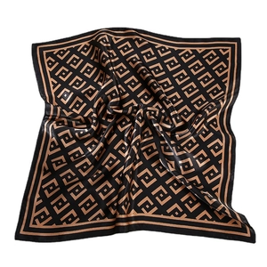 Elegant black silk square scarf with gold geometric pattern shown on white background