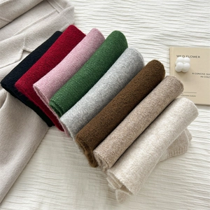 Macro shot of knitted wool scarves in eight colors with soft texture and neat edges