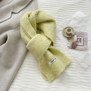 Close-up of knit wool scarf with a vegetable label and fuzzy mohair-like texture