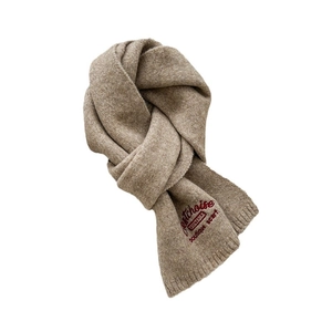 Brown knitted wool scarf with embroidery, elegantly knotted on a white background