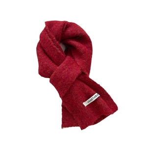 Solid red wool knit scarf with a stylish Vegetable patch in a knotted display