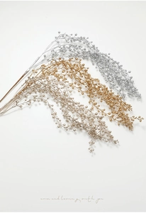 Macro detail of metallic gold, silver and champagne glitter berry stems for Christmas