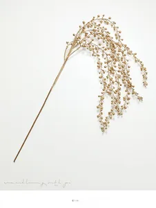 Detailed view of artificial golden berry stems with shiny metallic finish for holiday decor