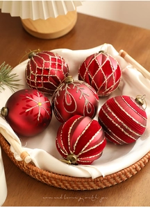 Close-up of red and gold Christmas ball ornaments with glitter and matte finishes