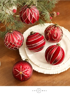 Detailed view of 8cm red Christmas balls with glitter snowflake and geometric patterns