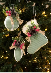 Detail of Christmas tree ornaments featuring green fabric balls and pine cones
