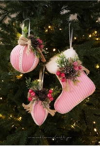 Pink knit Christmas ball and stocking ornaments with pine cones and berries on tree