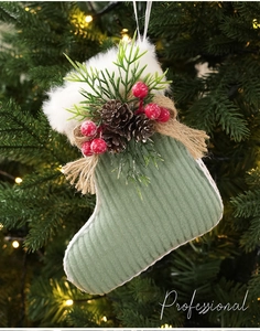 Detail of green corduroy Christmas stocking ornament with pine cones and red berries