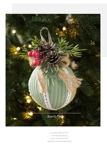 Close-up of 8cm green knit Christmas ball with pine cone and berries hanging on a tree